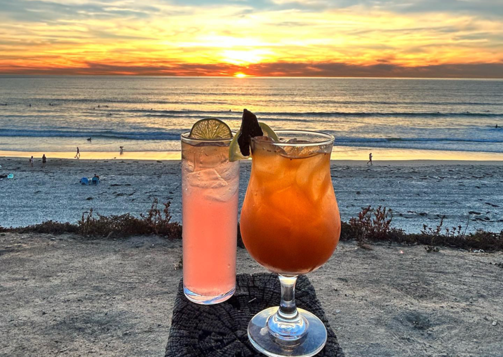 two cocktails in front of beach sunset