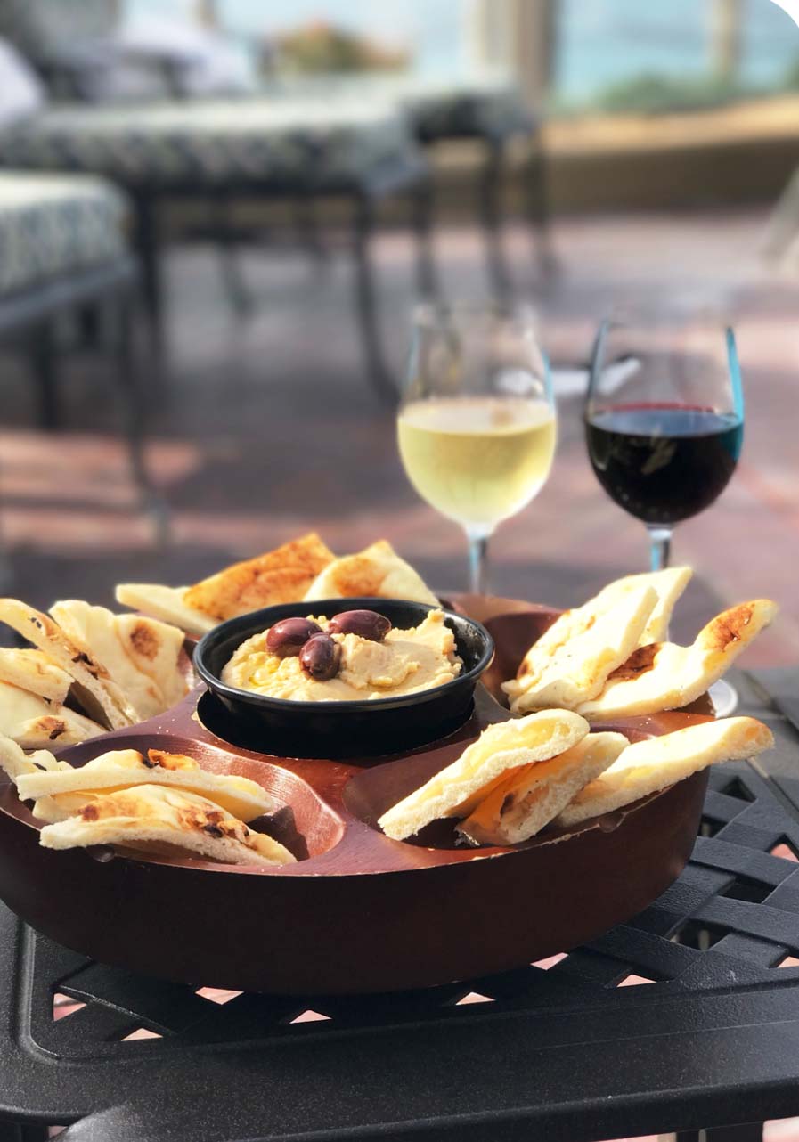 Hummus dip with bread, and wine