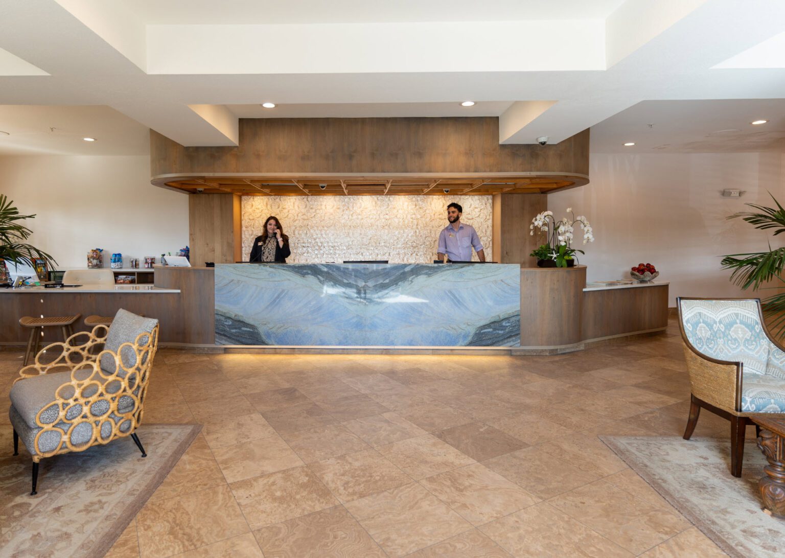 Refreshed lobby front desk with smiling attendees