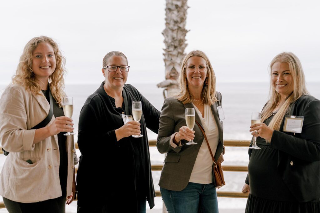 People holding champagne and smiling