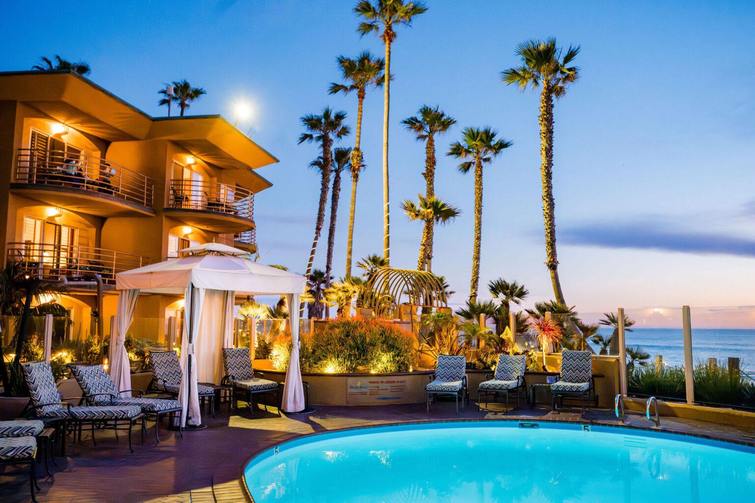 Poolside view of the hotel at sunset