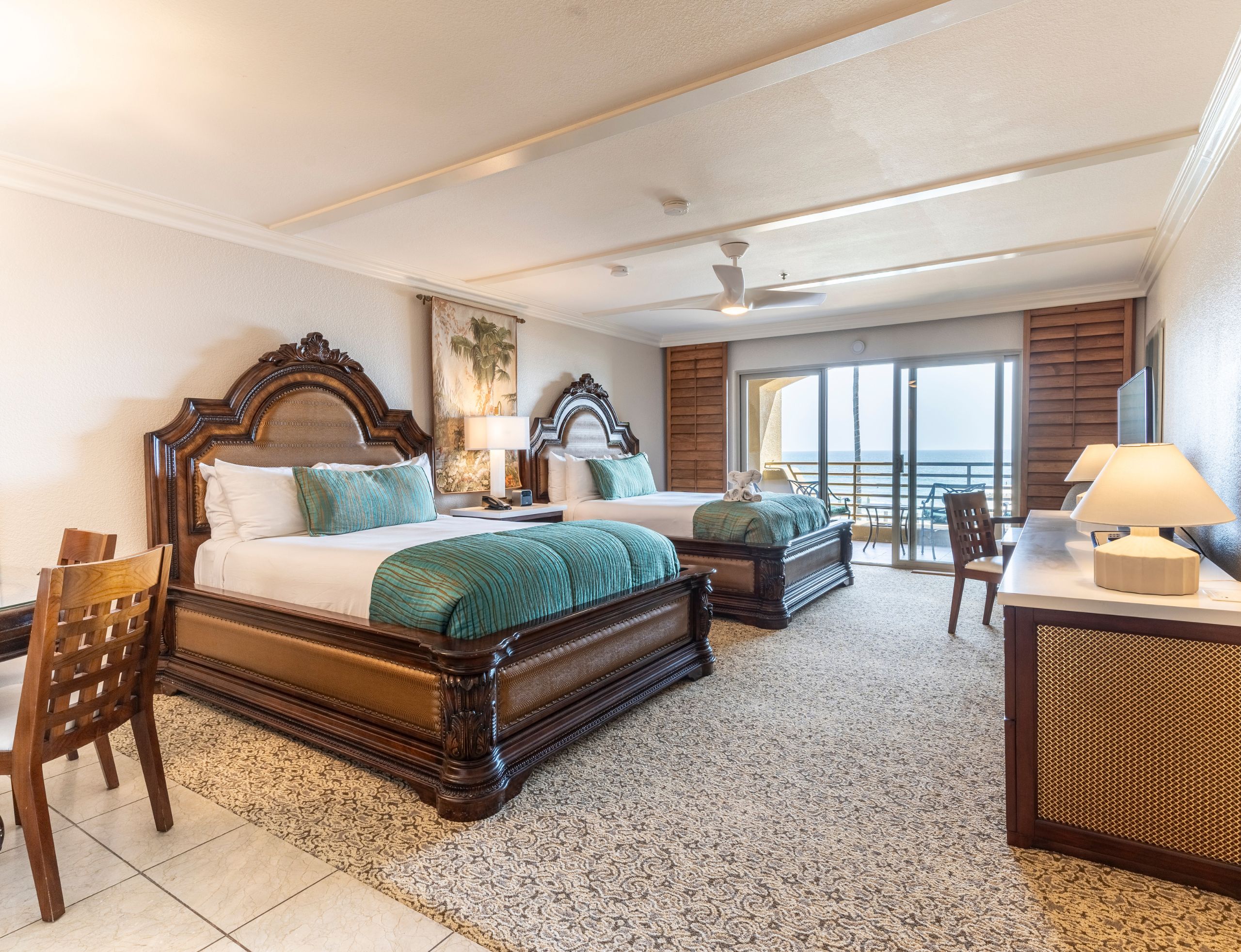Two queen beds with partial view of the ocean