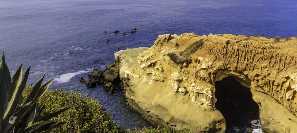 a large rock reaching out into the ocean