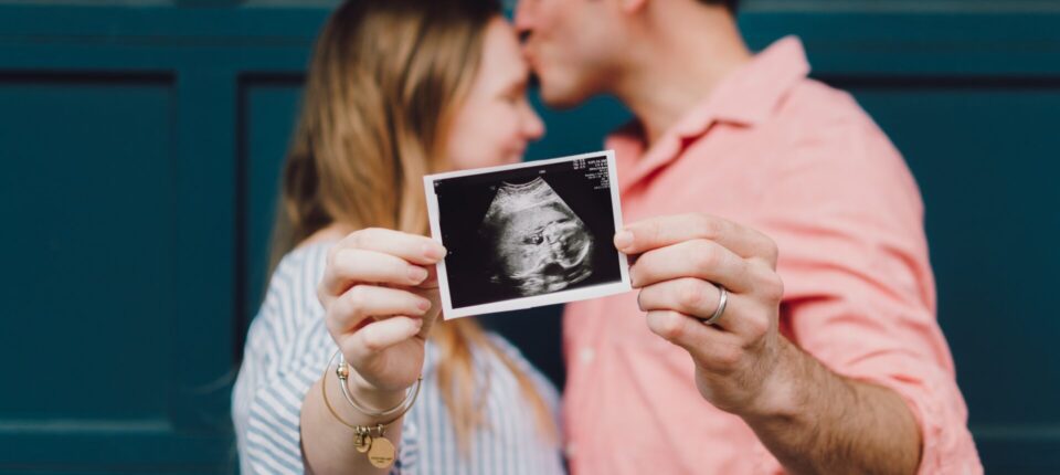 a couple holding an ultrasound image