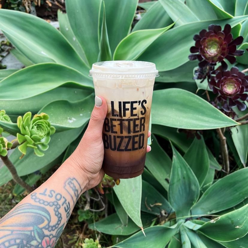 person holding a coffee from better buzz