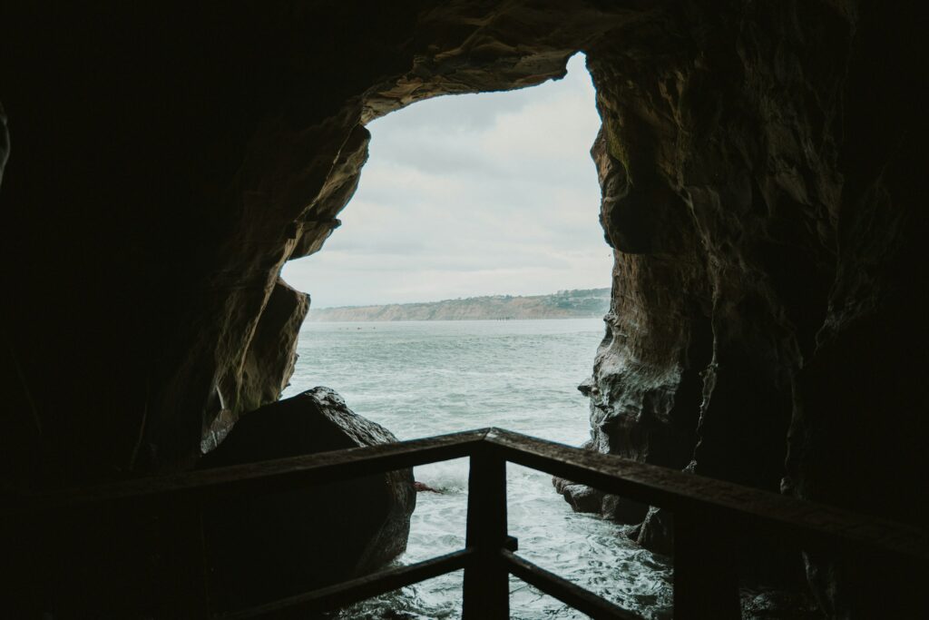 a view of the sea through a cave