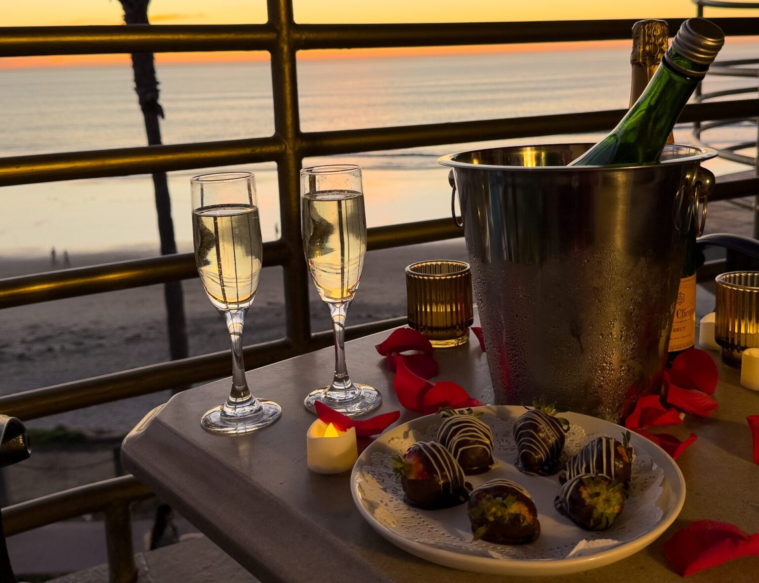 bottle of champagne and chocolate covered strawberriess