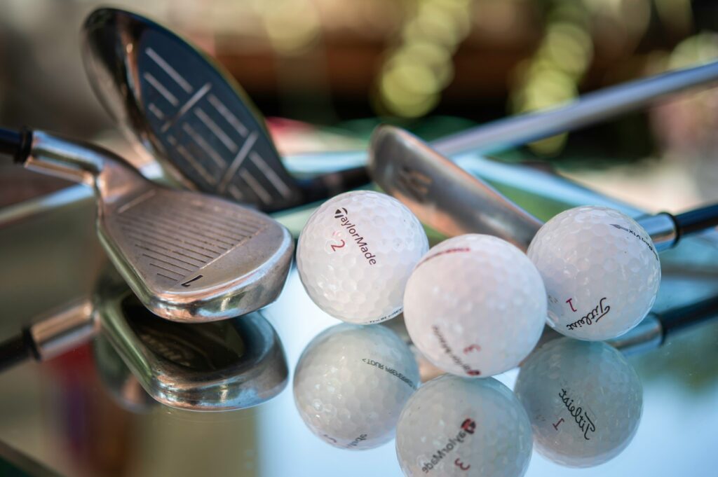 Golf clubs and balls shot close up.