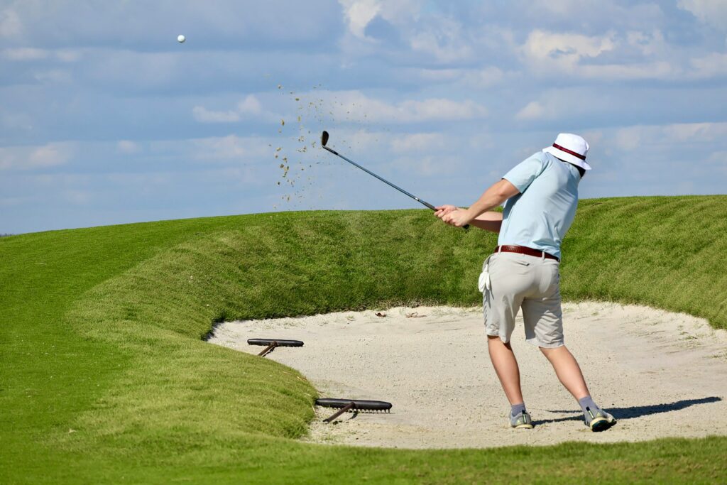 a golfer in the sand